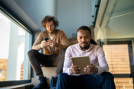 Multiethnic professional business people, programmer working with mobile devicesの写真素材