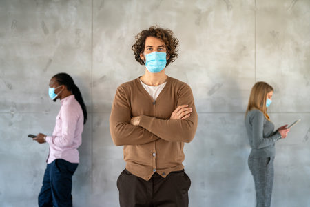 New normal and social distancing concept. Businessmen and businesswoman wearing face mastの写真素材