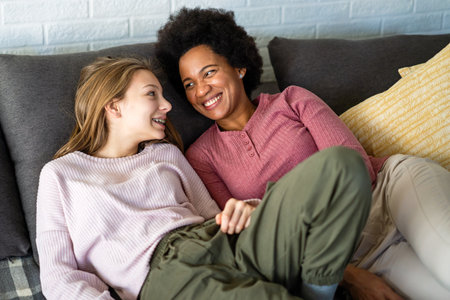 Loving african american foster care parent single mother embrace teen daughterの写真素材