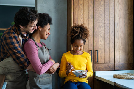 Happy multiethnic family in love together in kitchen. Parents child together conceptの写真素材
