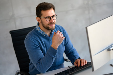 Success young professional businessman investor,manager at workplace working on computer in officeの写真素材