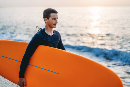 Summer adventure water sports concept. Happy carefree man surfing, living healthy active lifestyleの写真素材