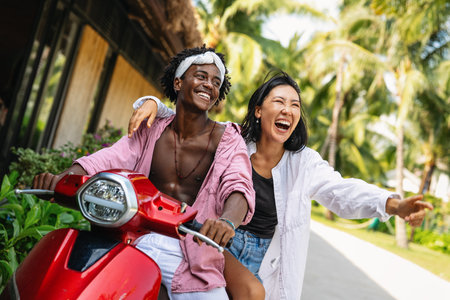 Happy couple having fun at the beach, playing and laughing together in a romantic tropical setting