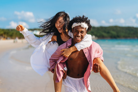 Carefree couple enjoying a tropical beach vacation, laughing making unforgettable memories togetherの写真素材