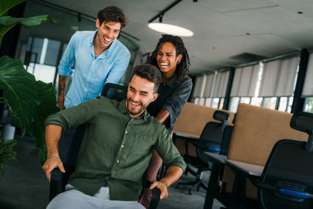 Group of young multiracial diverse office workers is caught in a moment of spontaneous joy.の写真素材