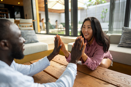 Handshake between people of different ethnicities, symbolizing trust, harmony, belonging, and unityの写真素材