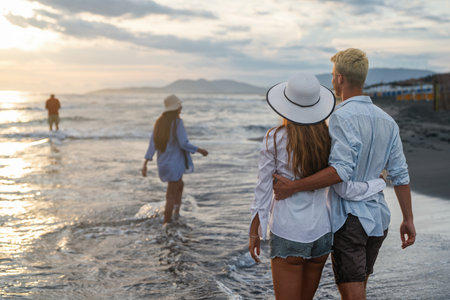 Young couple walking in the sea while smiling and enjoying summer vacation, travel togetherの写真素材