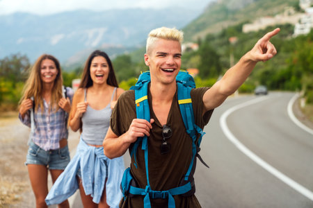 Friendship, travel, vacation, summer and people concept. Group of smiling friends with map travelingの写真素材