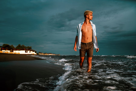 Smiling man on a tropical beach, enjoying his summer vacation. Travel people happiness conceptの写真素材