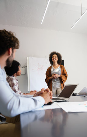 Young businesswoman leading a discussion during a meeting with her colleagues.の写真素材
