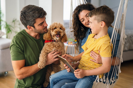 Happy family parents and kid use laptop phone digital tablet at home,の写真素材