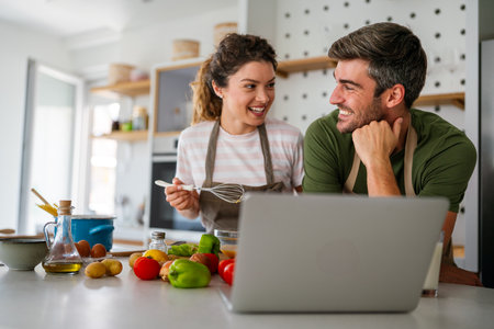 Secret ingredient is love. Couple preparing a healthy meal together while spending free time at homeの写真素材