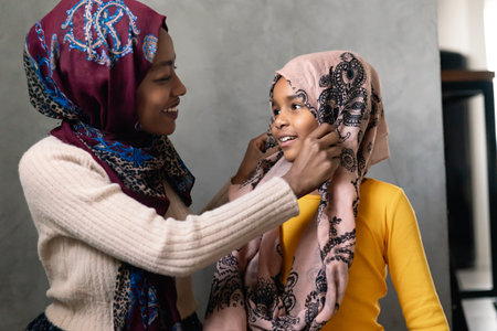 Muslim single parent. Portrait of a mother and child together at homeの写真素材