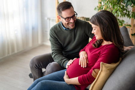 Man in love hugs his pregnant wife, they are waiting together for the babys arrival. Love, familyの写真素材