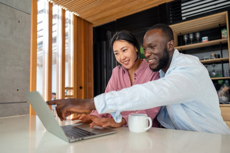 A happy, multi-national couple who are digital nomads and work from a different country every monthの写真素材