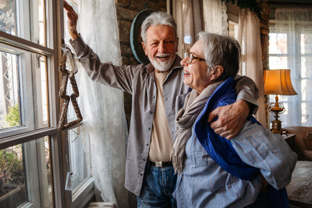 Happy senior adult mature pensioner couple hugging, bonding, thinking of good futureの写真素材
