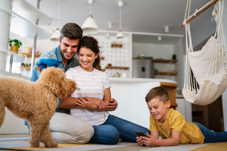 Mother, father and kid with dog in living room for quality time, love and care together on weekendの写真素材