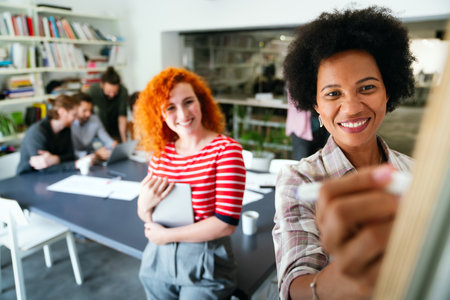 Two businesswoman working together using digital tablet pc and talking about a business project.の写真素材
