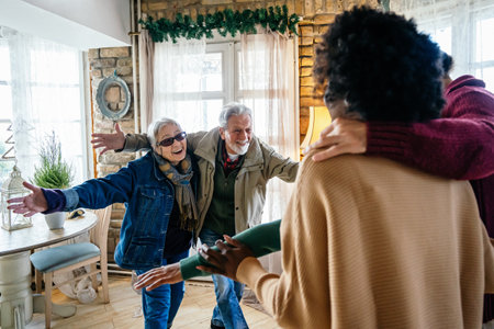Excited multiethnic family greeting grandparents on Christmas Day. Multi-generational happy familyの写真素材