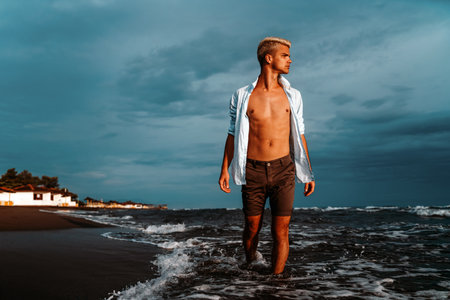 Stylish man relaxing at tropical beach during summer vacation. Carefree guy relaxing at sea.の写真素材