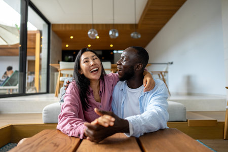 Interracial couple embracing celebrating love, diversity, and unity in a supportive relationshipの写真素材