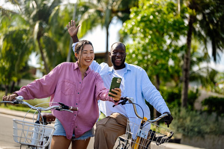 Interracial couple embracing technology, diverse couple enjoying vacation travel relaxationの写真素材