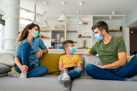Sad family wearing protective medical mask for prevent virus, flu, pollution. Family protectionの写真素材