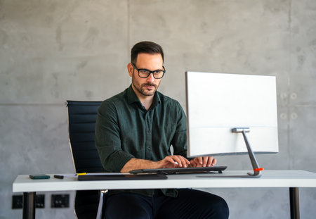 Success young professional businessman investor,manager at workplace working on computer in officeの写真素材