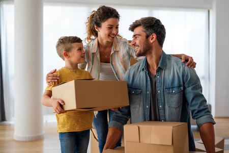 Moving, parents and child in new home bonding together, unpacking boxes for family time