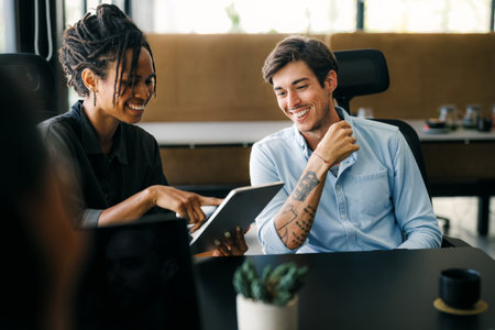 Group of young multi-ethnic startup business team collaborating on project in modern office