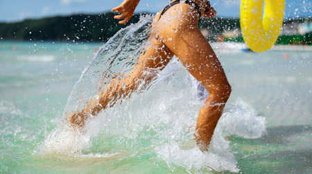 Smiling young asian woman enjoys every moment of her tropical escape, playing on the beachの写真素材