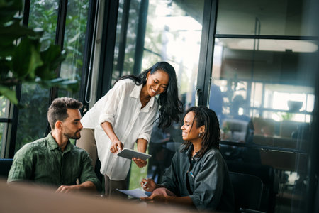 Group of busy happy diverse professional business team people working in office using digital tabletの写真素材