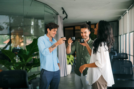 Young multiracial colleagues friends chatting discussing work company policy during coffee breakの写真素材