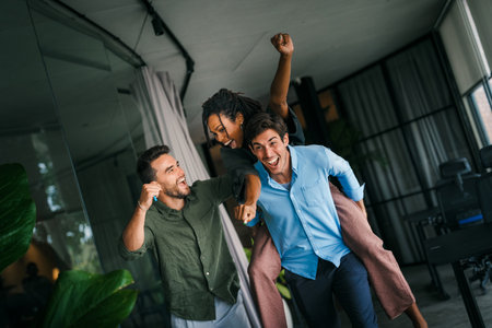 Group of young multiracial diverse office workers is caught in a moment of spontaneous joy.の写真素材