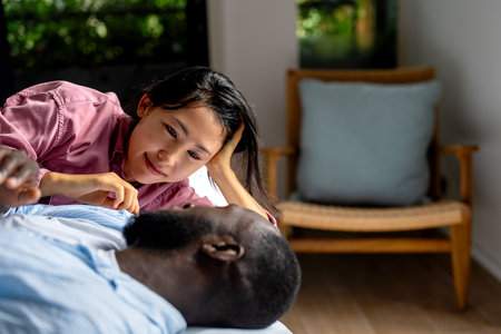 Joyful African-Asian couple embracing their diverse backgrounds, celebrating togetherness, identityの写真素材