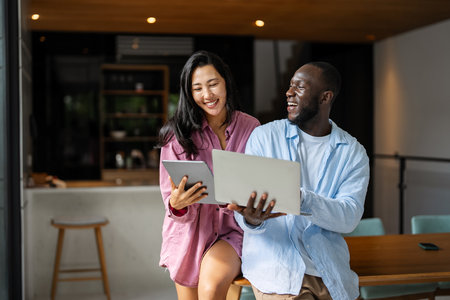 A happy, multi-national couple who are digital nomads and work from a different country every monthの写真素材