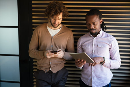 Two happy busy professional business men executive business team working togetherの写真素材