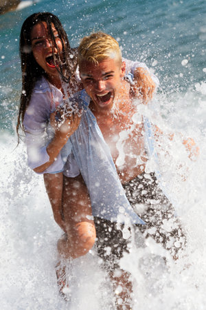Running free by the waves. Celebrating youth, love, and the pure freedom with summer travel