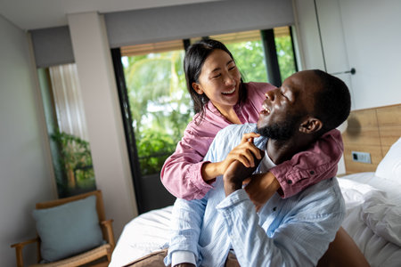 Interracial couple embracing celebrating love, diversity, and unity in a supportive relationshipの写真素材