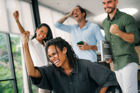 Joyful, excited diverse entrepreneurs are celebrating their success and the great work environmentの写真素材
