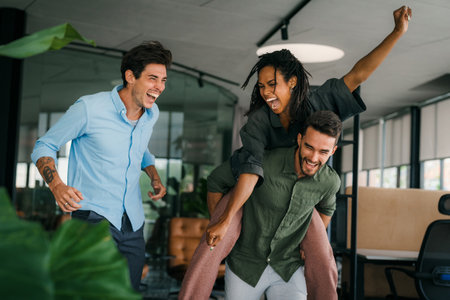 Portrait of overjoyed young diverse employees workers in creative modern office. Team buildingの写真素材