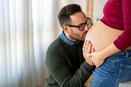 Man in love hugs his pregnant wife, they are waiting together for the babys arrival. Love, familyの写真素材