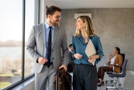 Portrait of successful business people working, talking together in corporate office during work.の写真素材