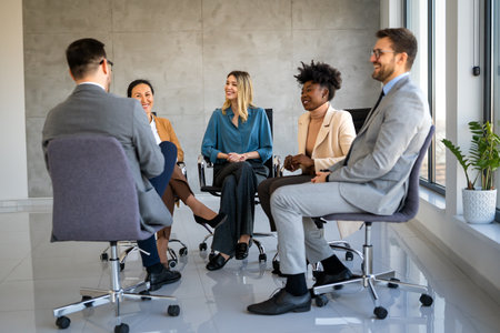 Diverse business people sitting in circle at group therapy session. Business coach training staffの写真素材