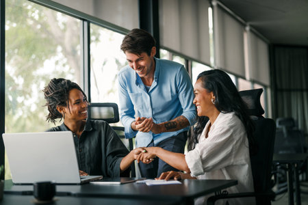 Multicultural professional businesspeople working together on research plan in boardroom.