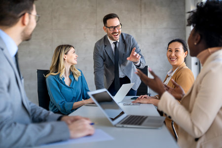 Multicultural professional businesspeople working together on research plan in boardroom.の写真素材