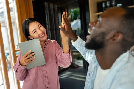 Successful couple working together, celebrating shared achievements. Positive collaborationの写真素材