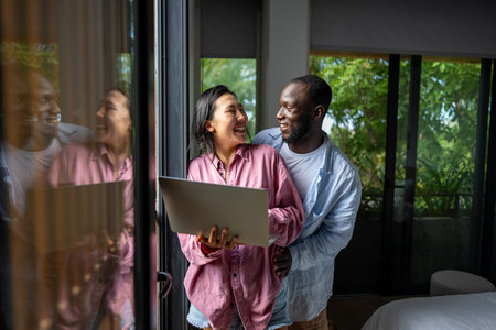 Man and woman working remotely using laptop. Male female freelancers working together. Digital nomadの写真素材