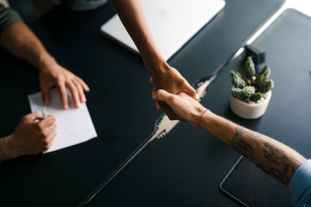 Modern, inclusive, and collaborative atmosphere in the office. They warmly welcome the new colleagueの写真素材