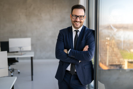 Handsome young business man standing confident in the corporate office in front of his teamの写真素材
